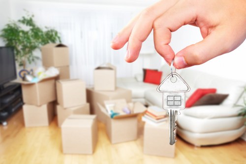 Moving team with safety equipment and protected furniture during a van loading process