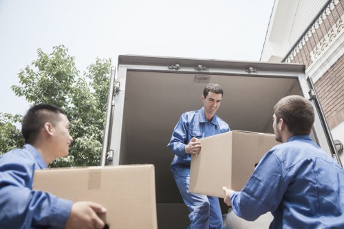 Specialist team handling an upright piano move in Kingston upon Thames