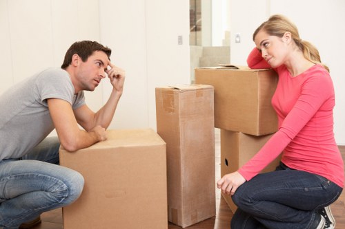 Removal team carrying household items during a move in Kingston upon Thames