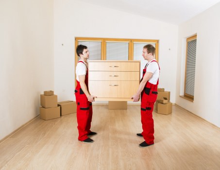Professional moving van preparing household items for transport